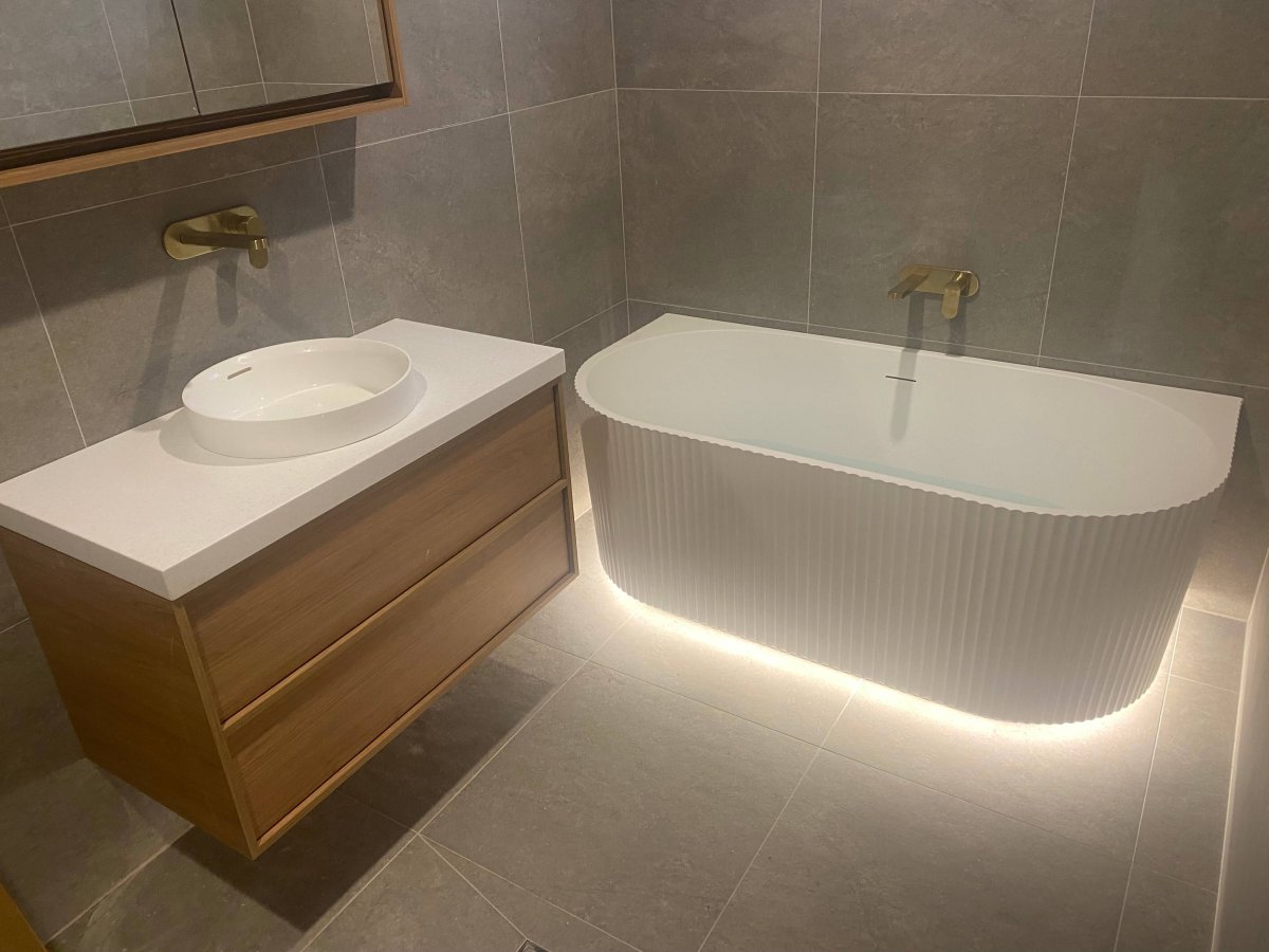 LED downlight installation in modern Bangalow bathroom